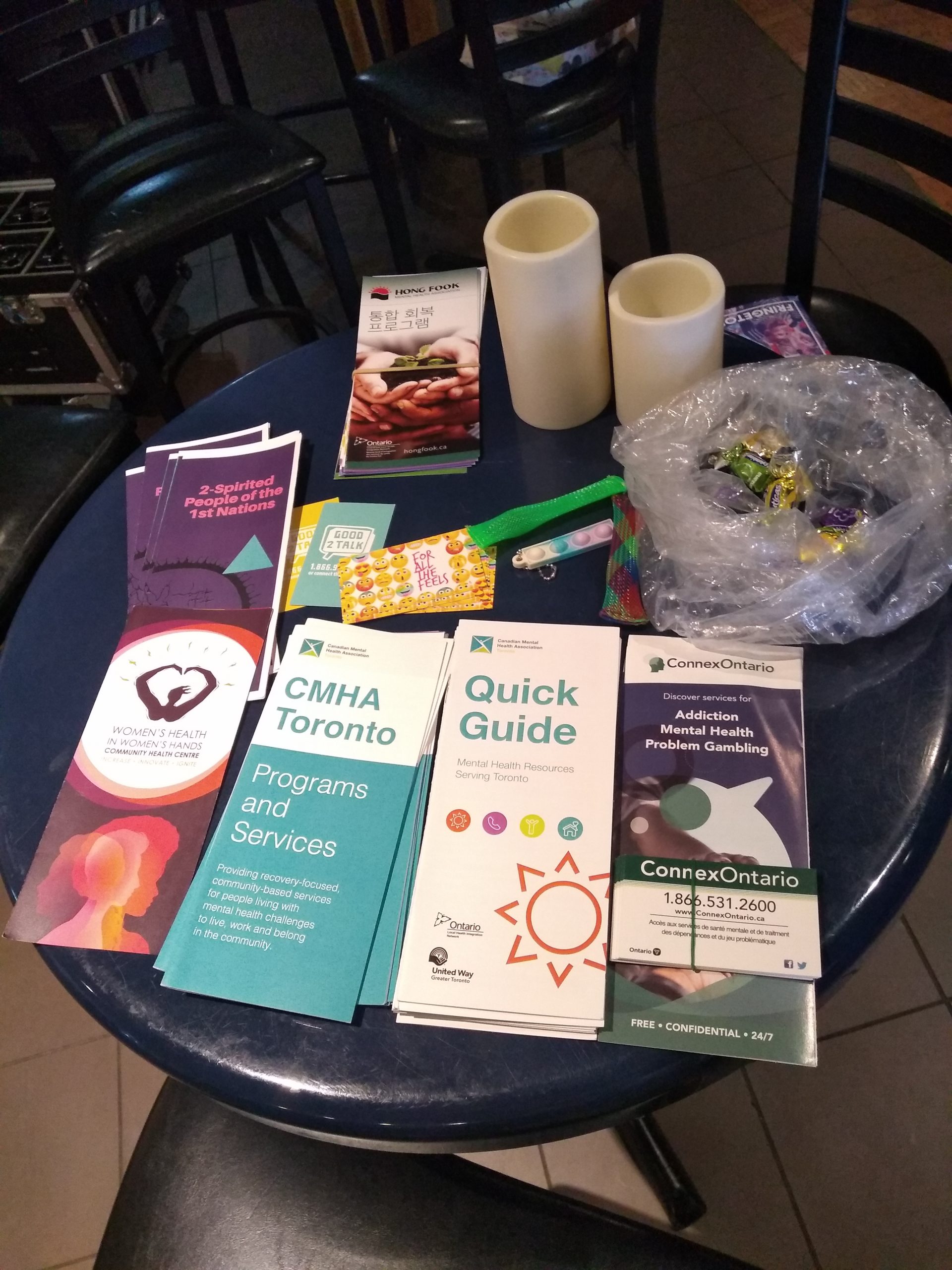 Small resource table with pamphlets, bag of candy and candles