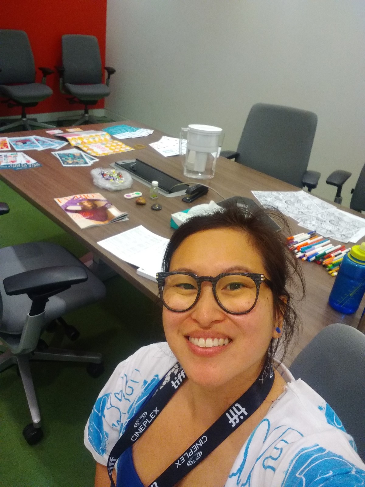 Amanda in glasses in front of Toronto International Film Festival resource table.