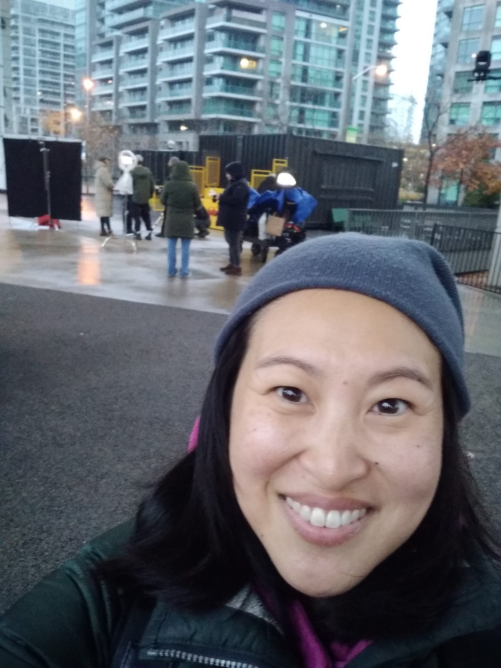 Smiling selfie with film crew behind