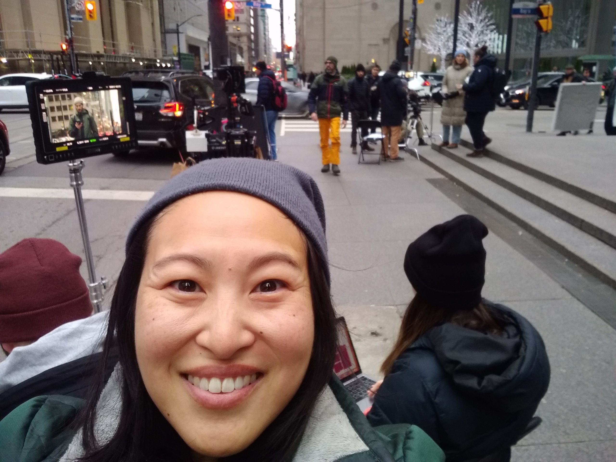 Selfie outside on street with film shoot in background